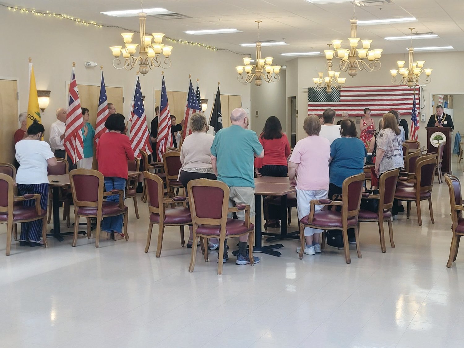 THE FLAG THAT UNITES US: Officers and members of Warwick’s Tri-City Elks Lodge led songs and delivered readings during a Flag Day ritual held Tuesday for the members of the Johnston Senior Center.